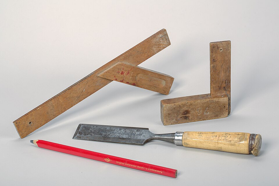 Bevel-edge chisel with layout tools on a workbench