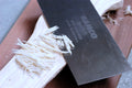 Card scraper with wood shavings